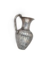 An East Greek cast silver juglet with tooled decoration, circa 4th Century B.C., with piriform bo...