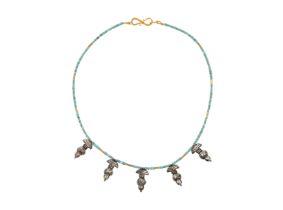 To Be Sold With No Reserve A silver bird pendant necklace, on a string of turquoise and gold bea...