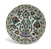An Iznik pottery dish depicting a ewer, Ottoman Turkey, early 17th century, decorated in undergla...