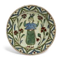 An Iznik figural polychrome pottery dish, Ottoman Turkey, mid-17th century, decorated in undergla...