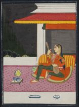 A lady playing the sitar, Rajasthan, North India, 20th century, reclining on a bolster under an a...