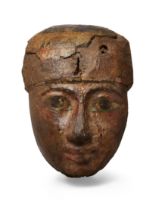 An Egyptian polychrome painted wood coffin mask, Third Intermediate Period, circa 1069-715 B.C., ...