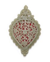 A drop-shaped, carved and openwork pale green jade mirror, India, late 19th century, with a large...