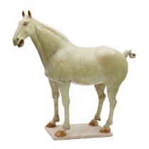 A rare and magnificent Chinese glazed pottery horse  Tang Dynasty  Powerfully modelled standing...