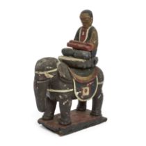 A Himalayan lacquered figure on an elephant 19th century Seated on a lotus throne over a capari...