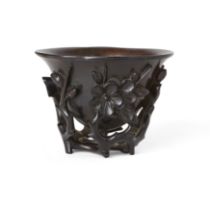 A Chinese zitan 'prunus and magnolia' cup Qing dynasty, 17th/18th century  Finely carved and pi...