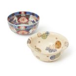 A Japanese Satsuma bowl and an Imari bowl Meiji period, 19th century The Satsuma bowl decorated...