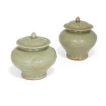 A pair of Chinese Longquan celadon 'floral' jarlets and covers Ming dynasty, 14th/15th century ...