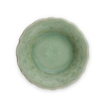 A small Chinese Longquan celadon-glazed carved 'peony' dish Ming dynasty, 15th century With fol...