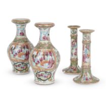 A pair of Chinese Canton famille rose vases and a similar pair of candlesticks Qing dynasty, 19t...