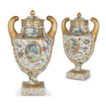 A pair of Chinese export famille rose pistol-handled urns and covers Qing dynasty, Jiaqing perio...