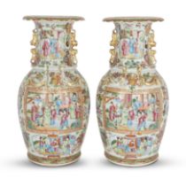 A pair of Chinese Canton famille rose baluster vases Qing dynasty, 19th century Each painted to...