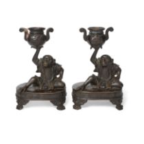 A pair of Japanese bronze 'monkey' candlesticks  Meiji period Each seated on an oval base with ...