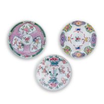 Three Chinese famille rose saucers Qing dynasty, Yongzheng period One painted to the central re...