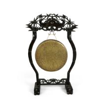 A Chinese copper-alloy circular gong and hardwood stand Republic period The stand carved and pi...