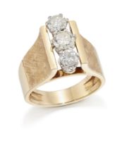 A three stone diamond ring, with a row of graduated brilliant-cut diamonds, claw set to tapering ...