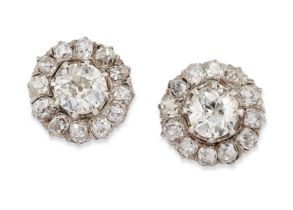 A pair of diamond earstuds, of cluster design, with an old European-cut diamond, claw set, to sur...