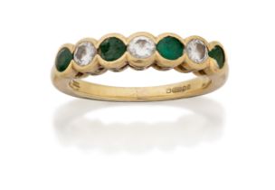 An 18ct gold emerald and diamond five stone half eternity ring, the half-hoop collet-set with thr...