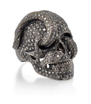 Theo Fennell. A black diamond skull ring, realistically modelled as a skull with interwoven snake...