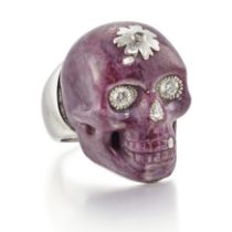 Theo Fennell. An 18ct white gold carved ruby and diamond skull ring, the realistically modelled s...