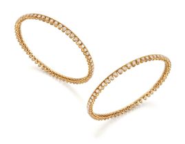 A pair of diamond set bangles, each bangle composed of a continuous row of brilliant-cut diamonds...