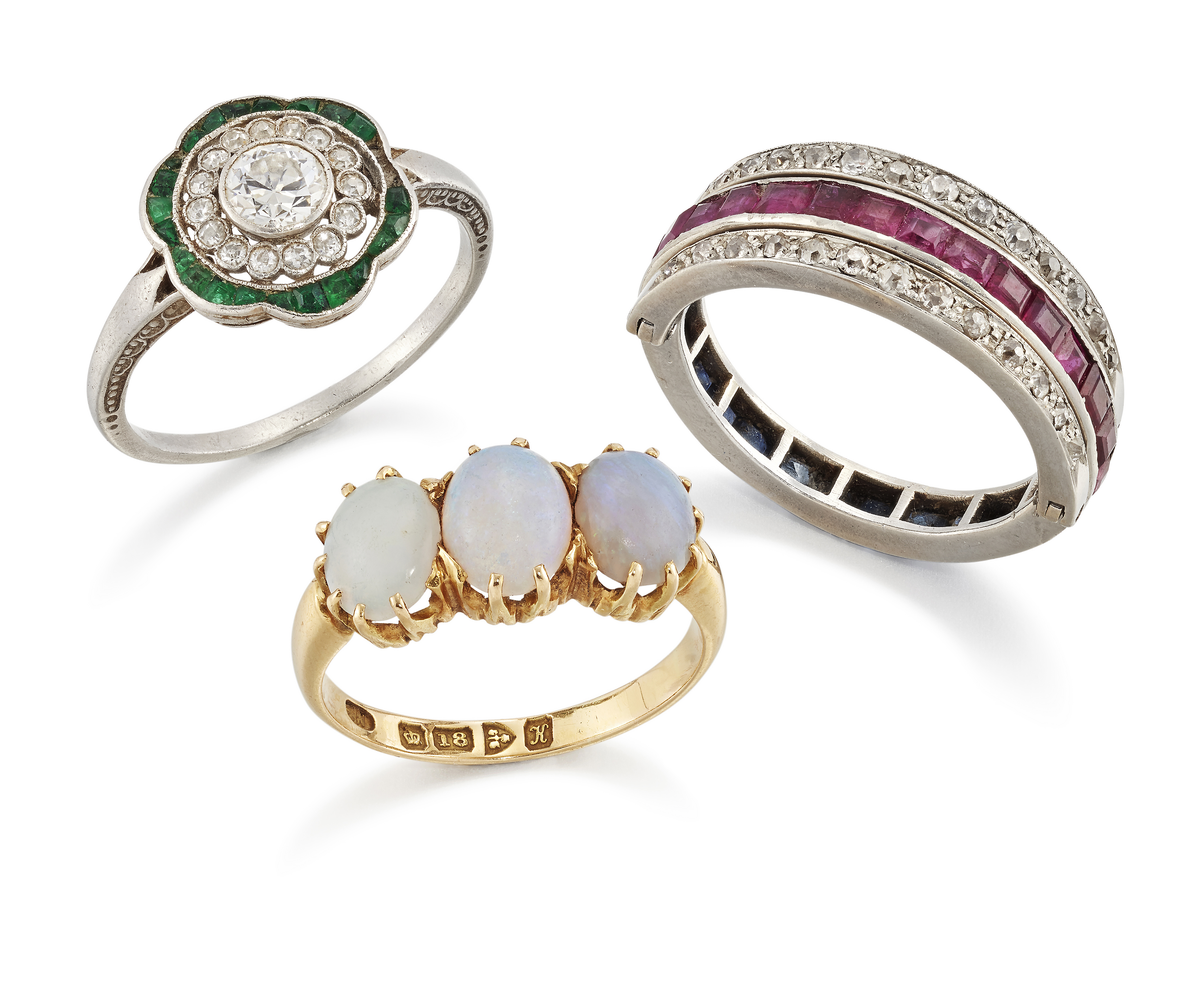Three diamond and gem set rings, comprising: an Art Deco platinum diamond and emerald target clus...