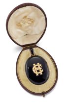 Henry Tessier. A Victorian onyx locket pendant, of oval form, with applied half-pearl set initial...