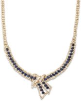 A sapphire and diamond flexible necklace, composed of a central baguette diamond and oval cut sap...