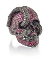 Theo Fennell. A ruby and black diamond skull ring, realistically modelled as a skull with interwo...