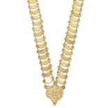 A gold neck chain, with pierced scroll panel to shaped panel links joined by pairs of figure of e...