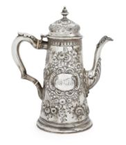 An 18th century silver coffee pot Apparently unmarked The body richly repousse decorated with s...