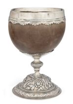 A silver mounted coconut cup  Unmarked Probably late 18th/early 19th century  Raised on a dome...