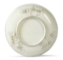 A Meissen Böttger porcelain white glazed saucer, c.1715-20, the exterior applied with three rose ...