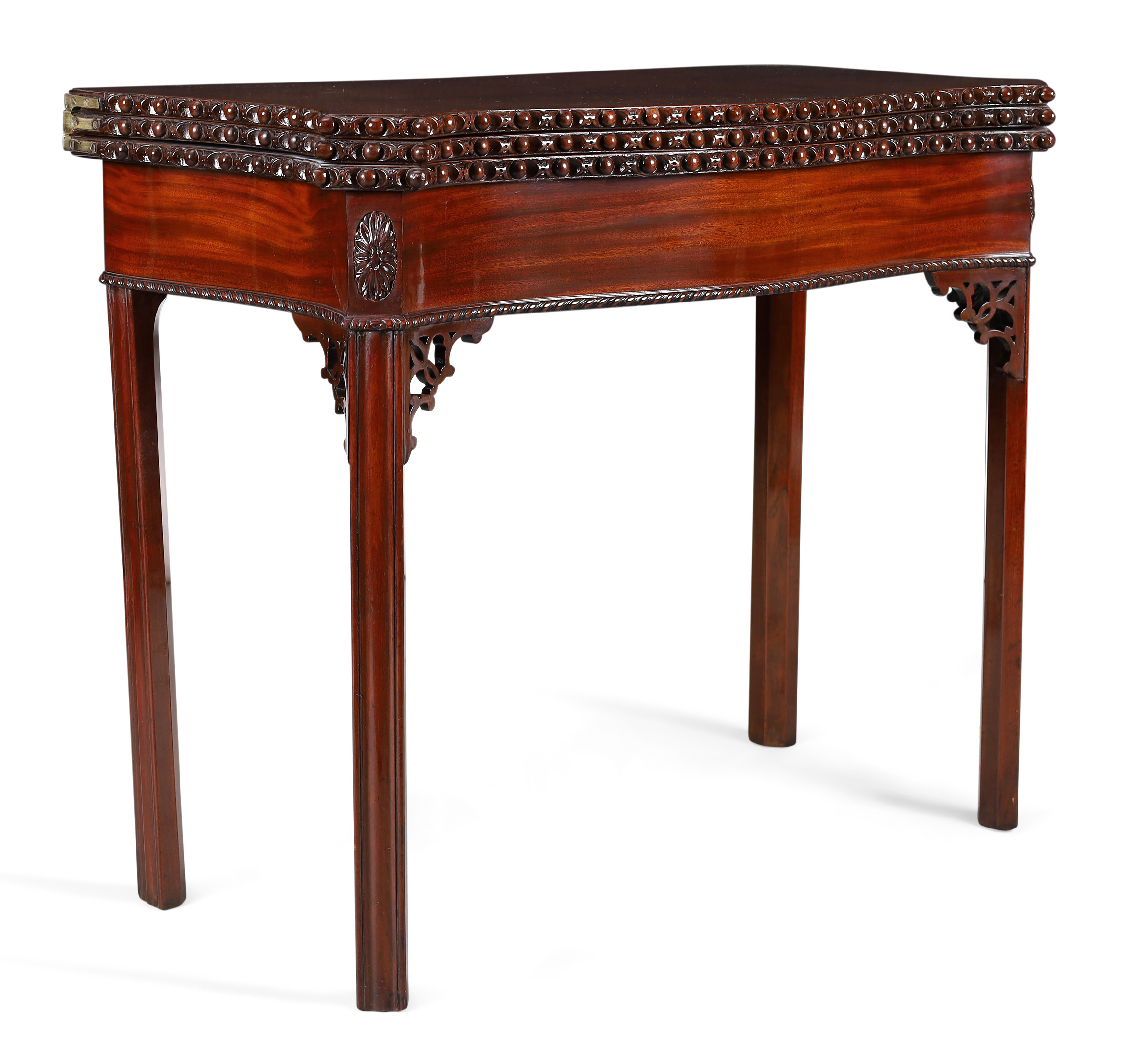 A George II mahogany serpentine front triple fold tea/card table, in the manner of Thomas Chippen...
