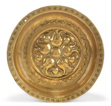 A German brass alms bowl, Nuremberg, first half 16th century, with floral motifs to the well and ...