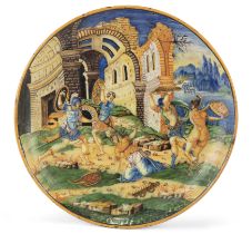 An Italian maiolica istoriato dish, 19th century, the well painted with a scene of Tarpea being b...