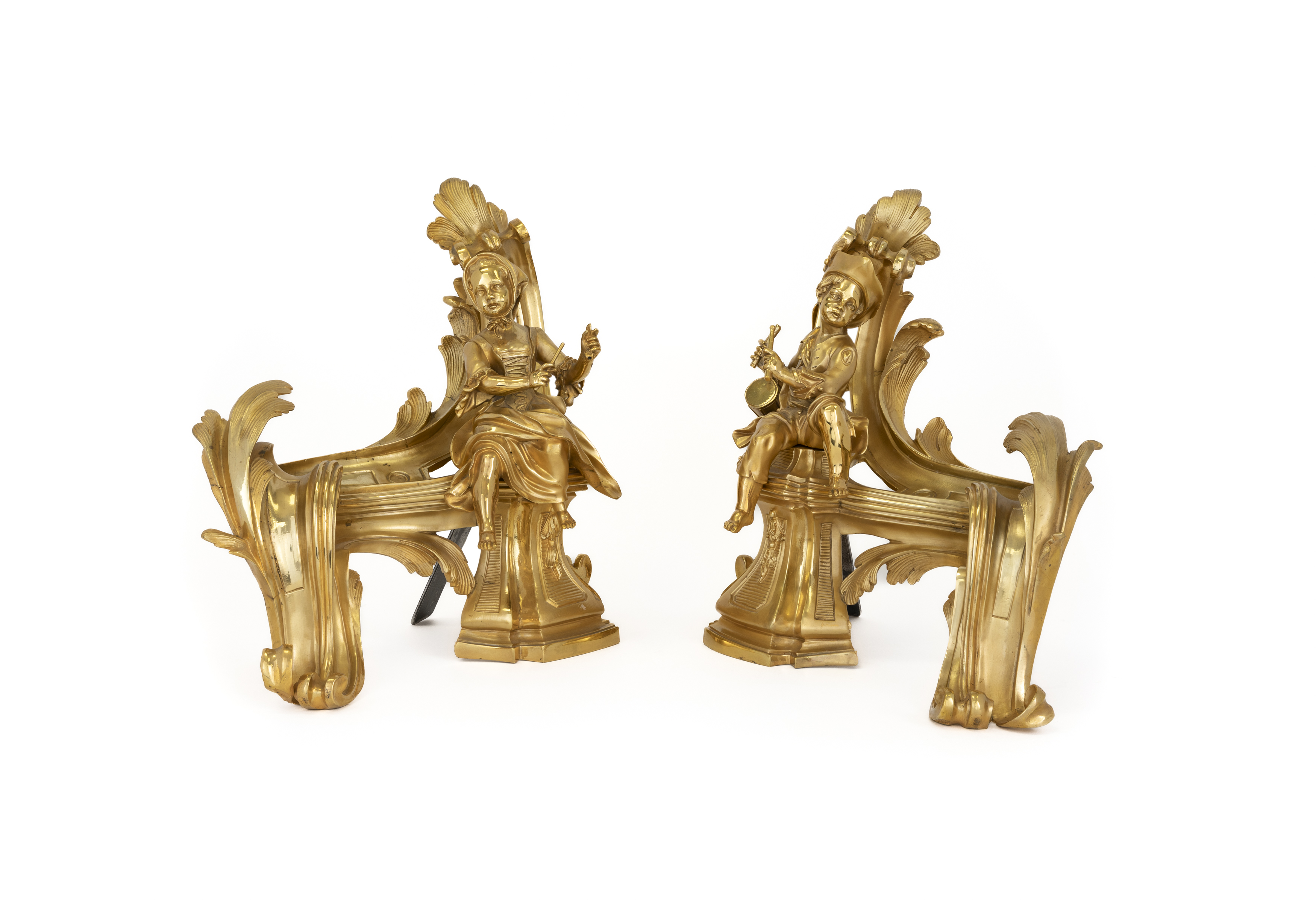 A pair of French gilt-bronze figural chenets, of Louis XV style, 20th century, each of scrolling ...