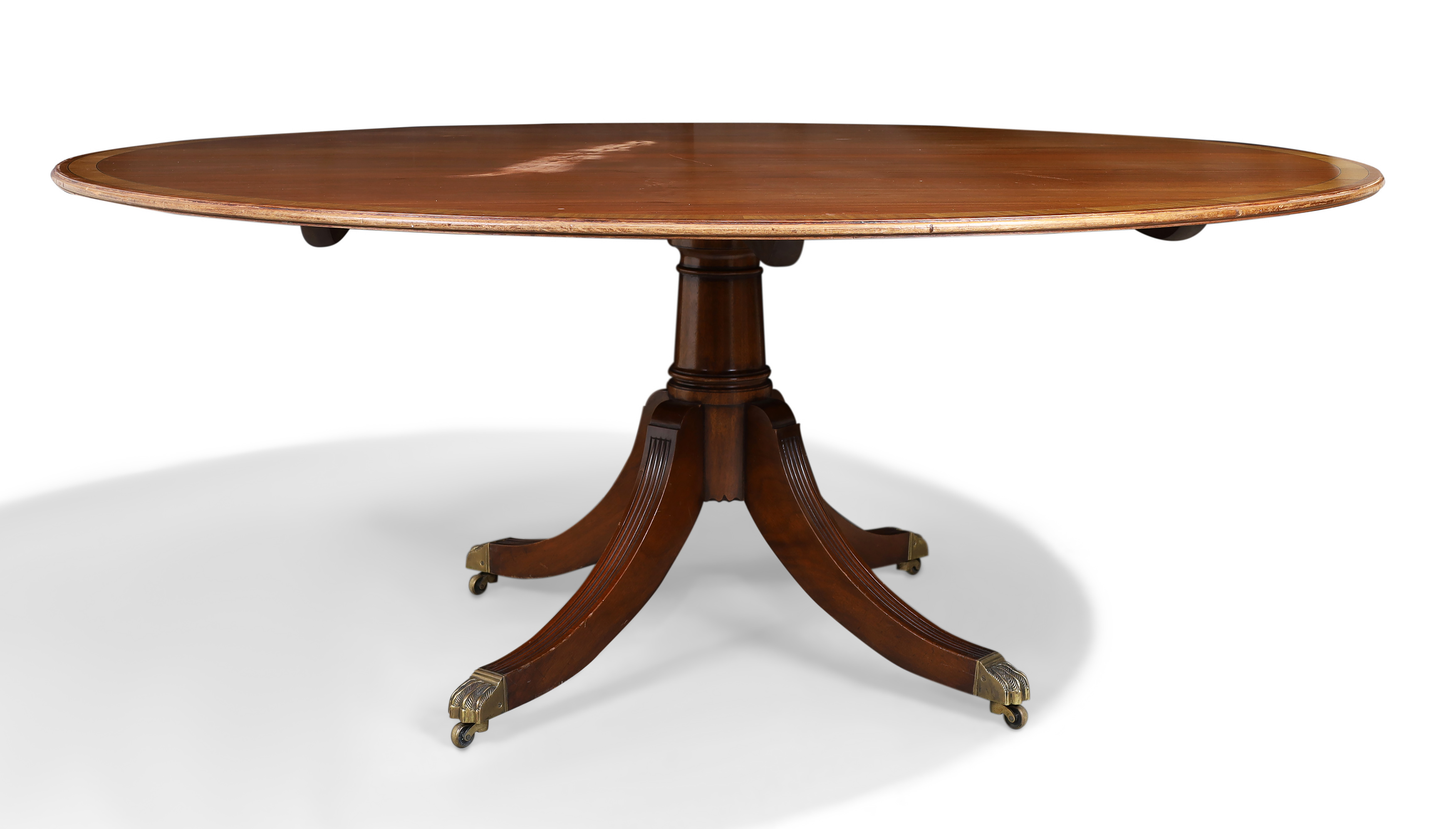 An English mahogany circular dining table, by Arthur Brett, of George III style, 20th century, th...