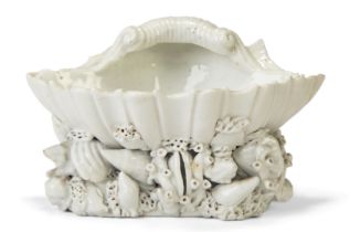 A Plymouth porcelain white glazed salt, c.1770, the large shell supported on a base of further sm...