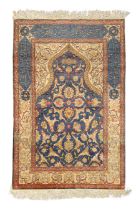 A Turkish silk Hereke rug, second quarter 20th century, the mihrab field with floral motifs on a ...