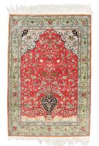 A Persian silk Qum rug, second quarter 20th century, the central field with vase of flower design...