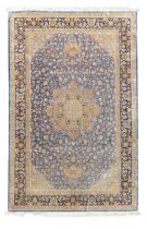 A Persian silk Qum carpet, last quarter 20th century, the central field with floral roundel medal...