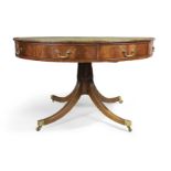 An English mahogany library drum table, of George III style, 20th century, the tooled leather top...