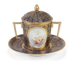 A Nyon porcelain blue-ground two-handled cup, cover and stand, blue fish mark, the ground gilded ...