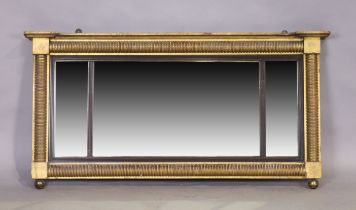 A Regency giltwood triple plate mirror, first quarter 19th century, with ring turned half columns...