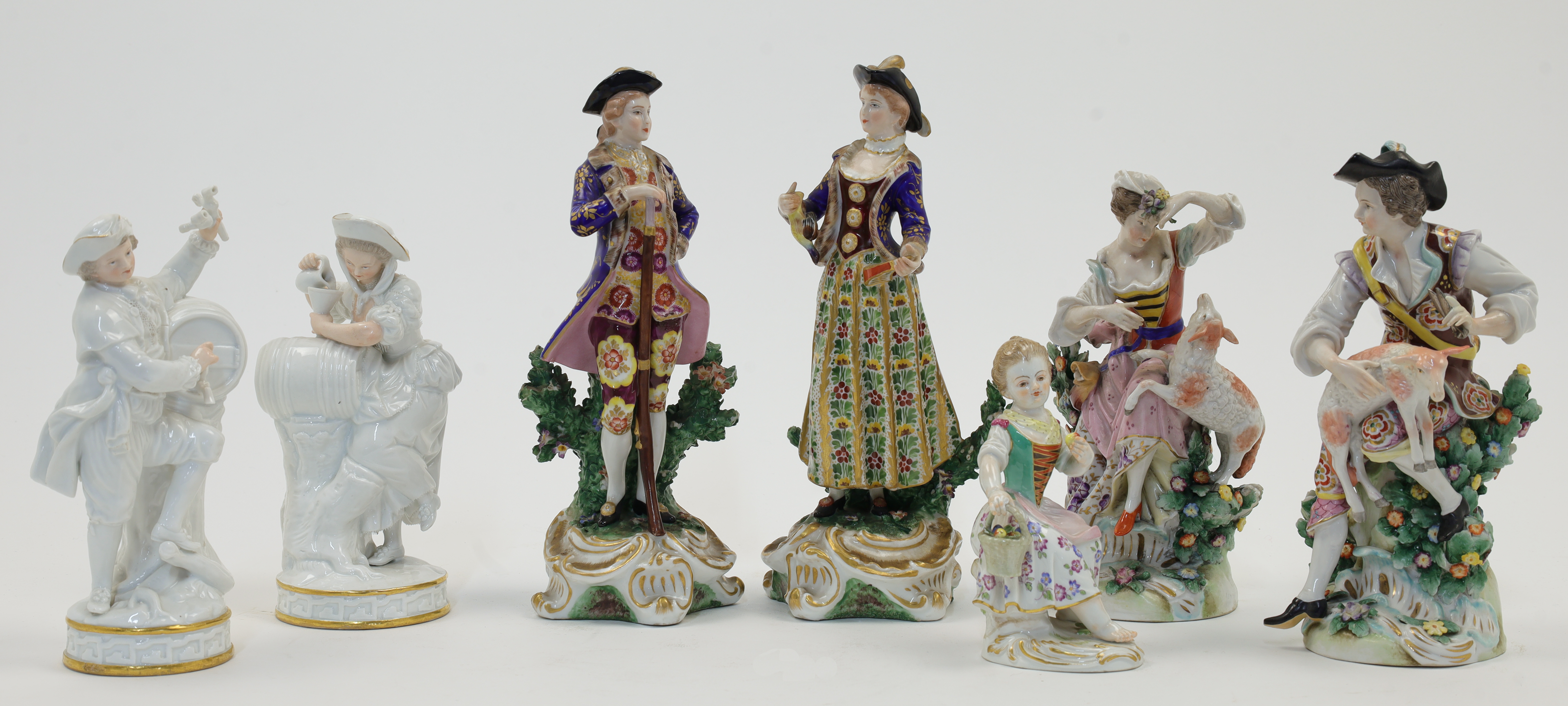 A group of Continental porcelain figures, to include: a pair of Meissen male and female vintners,...