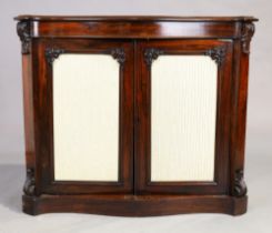 A Victorian rosewood serpentine front two door side cabinet, third quarter 19th century, two glaz...