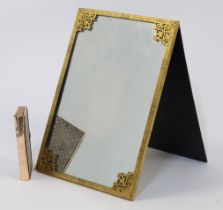 A gilt-brass mounted easel mirror, with engraved and pierced scrolling foliate decoration and rec...