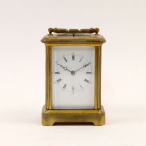 A gilt-brass repeating carriage clock, early 20th century, the glass panels with bevelled edges (...