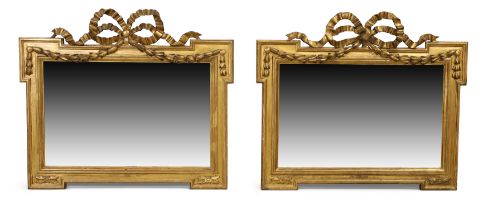 A pair of French giltwood mirrors, first quarter 19th century, the later rectangular plates with ...